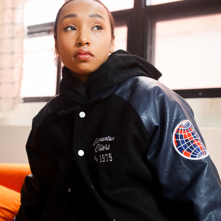 Edmonton Oilers Women's Peace Collective Black & Blue Cropped Varsity Jacket