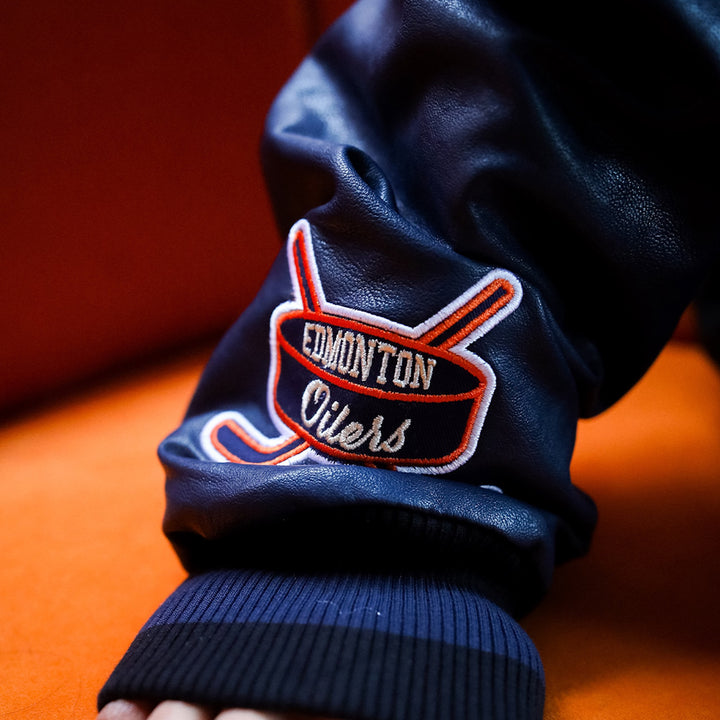 Edmonton Oilers Women's Peace Collective Black & Blue Cropped Varsity Jacket