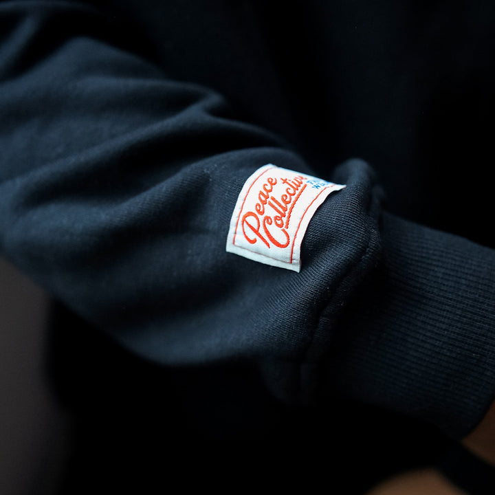 Edmonton Oilers Unisex Peace Collective Spirit Black Crewneck Sweatshirt